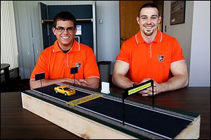 Bowling Green University engineering technology seniors Kevin Baumann, left, and Seth Cooper designed a system aimed to prevent wrong-way crashes. The effort was part of a ‘capstone’ senior project. They said they hoped a master’s student would take over the project.