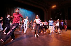 Students from the Toledo School for the Arts rehearse at the Ohio Theatre, from front left, Henry Tylinski, 13, Chloe Hudson, 13, and Khalil Carpenter, 12.