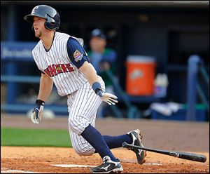 The Mud Hens' Bryan Holaday hits a double to drive in a run against the Charlotte Knights in the second inning at Fifth Third Field. Holaday had three hits.