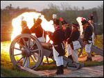  A cannon fires during half an hour of exchange Friday, May 3, 2013 between Fort Meigs in Perrysburg and other re-enactors on the opposite bank of the Maumee River. Several companies of re-enactors, including Fort Meigs' Cushings Company 2d Artillery, were present. 