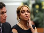  Actress Lindsay Lohan appears in Los Angeles court with her new attorney Mark Heller, left, for a pretrial hearing, Wednesday, Jan. 30, 2013, in a case filed over the actress' June car crash.