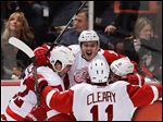  Red Wings center Gustav Nyquist, top, celebrates his winning goal with Jonathan Ericsson, left, Daniel Cleary, and Valtteri Filppula against the Anaheim Ducks during overtime in Game 2 on Thursday night. The series is now tied at a game apiece.