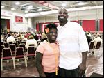  Alasha Higgs and her dad, Brad Higgs, share a moment before the start of commencement on Friday at Owens Community College's Perrysburg Township campus. Her father was selected to address fellow graduates during the school’s 47th annual commencement ceremony. 