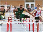  Start High School's Dionte Carey, center, outraces Clay's Jack Nagy, left, and Bedford's Trent Santiago to win the 110 meter hurdles during the Knight Relays at St. Francis. Findlay won the team title. STORY ON PAGE 3.