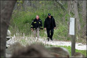 Massachusetts State Police walk out of the woods of the Smith Neck Farm in Dartmouth, Mass. as federal, state and local authorities on Friday searched the woods near the UMass-Dartmouth campus as part of the Boston bombing investigation.