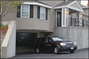 A vehicle believed to be carrying the body of Boston Marathon bombing suspect Tamerlan Tsarnaev backs into an underground garage at the Dyer-Lake Funeral Home.