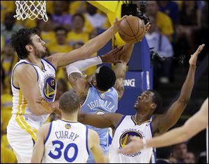 Golden State Warriors' Andrew Bogut, top left, blocks a shot by Denver Nuggets' Andre Iguodala, center, as Warriors' Harrison Barnes, right, watches during the first half of Game 6.