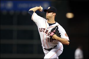 Houston Astros starting pitcher Jordan Lyles throws against the Detroit Tigers in the first inning.
