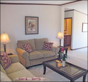 The living room is open to the dining area and kitchen. It’s ideal for entertaining guests.