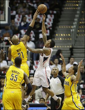 Atlanta Hawks point guard Jeff Teague has his shot blocked by Indiana Pacers power forward David West.