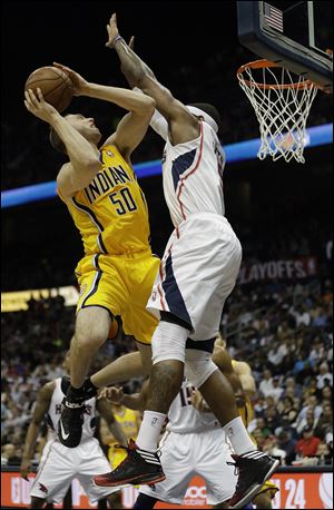 Indiana Pacers power forward Tyler Hansbrough tries to get to the hoop as Atlanta Hawks small forward Josh Smith defends.