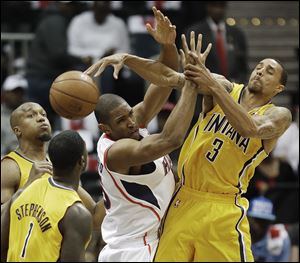Atlanta Hawks center Al Horford (15) loses the ball as Indiana Pacers point guard George Hill (3) and Indiana Pacers shooting guard Lance Stephenson (1) defend.