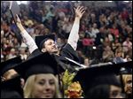  Eric Bernardo of Springfield, Ohio, celebrates graduation during commencement ceremonies at the BGSU Stroh Center Saturday.