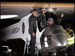  Solar Impulse co-founder, pilot and CEO Andre Borschberg, left, greets pilot Bertrand Piccard at Sky Harbor International Airport in Phoenix after completing the first leg of its coast-to-coast flights across the United States.