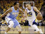  Golden State's Stephen Curry drives the ball against Denver's  Andre Iguodala. 