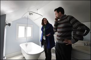 Christian Bell and his wife Beth Heinen Bell view a home for sale in Grand Rapids, Mich.