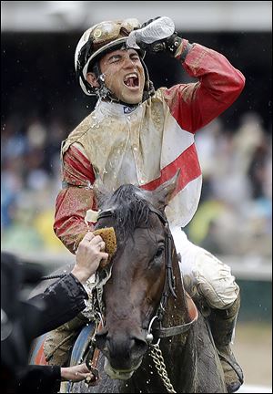 Joel Rosario celebrates after riding Orb to the winner’s circle on Saturday in the 139th Kentucky Derby.