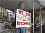  As the chair of the Citizens in Support of Our Schools committee, Grounds for Thought coffee shop owner Kelly Wicks campaigns for a BG school levy inside his downtown Bowling Green shop.