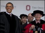  President Obama and Ohio State University President E. Gordon Gee arrive at the university’s spring commencement in Ohio Stadium last month.