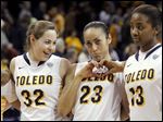  Flanked by UT teammates Ana Capotosto, left, and Mariah Carson, Inma Zanoguera shows a heart to her Spanish Club fans during a March game at Savage Arena. The Spaniard will enter her junior season among the top players in the league.