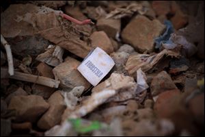 A clothes tag lies in the rubble of a garments factory that collapsed in Savar near Dhaka, Bangladesh.