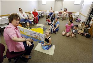Children's librarian Marge Bowerman reads Worms for Lunch during story time.
