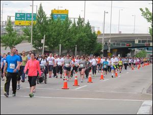 Thousands run and walk in a 5K on Saturday in front of the Cincinnati Bengals stadium as part of weekend-long events of the Flying Pig Marathon, now in its 15th year. A 5K and 10K on Saturday were sold-out, as were a half and full marathon set for today, with more than 33,000 participants expected overall. 