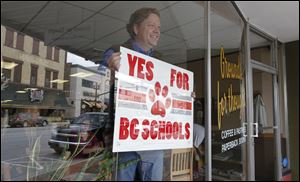 As the chair of the Citizens in Support of Our Schools committee, Grounds for Thought coffee shop owner Kelly Wicks campaigns for a BG school levy inside his downtown Bowling Green shop.