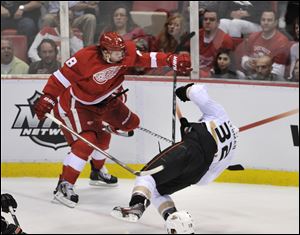 Detroit Red Wings left wing Justin Abdelkader (8) checks Anaheim Ducks defenseman Toni Lydman (32) during the second period in Game 3 in Detroit, Saturday. Abdelkader was ejected for the hit. 