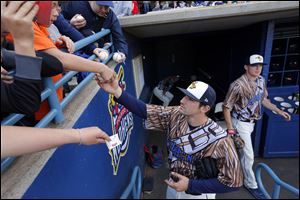 Mud Hens player Nick Castellanos (23) signs autographs before the Hens play the Charlotte Knights at Fifth Third Field, Saturday. The Mud Hens play again today at 2 p.m.