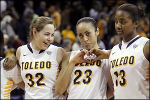 Flanked by UT teammates Ana Capotosto, left, and Mariah Carson, Inma Zanoguera shows a heart to her Spanish Club fans during a March game at Savage Arena. The Spaniard will enter her junior season among the top players in the league.