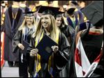  Sarah Hess, center, celebrates receiving her diploma during Sunday’s commencement ceremony at the University of Toledo. With the end of the academic year, 3,041 students were eligible for degrees.