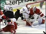  Anaheim Ducks left wing Matt Beleskey (39) trips over Detroit Red Wings right wing Daniel Cleary (11) as Detroit Red Wings goalie Jimmy Howard (35) defends in overtime of Game 4 of a first-round NHL hockey Stanley Cup playoff series in Detroit.
