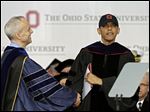  David Horn congratulates President Obama after he accepts an honorary doctor of laws degree at Ohio State's graduation ceremony at Ohio Stadium. Mr. Obama is the third sitting president to give Ohio State’s commencement address, following George W. Bush in 2002 and Gerald Ford in 1974.