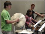  Maumee's Jayson Carey plays the crash cymbals during High School Band Day at Owens Community College.