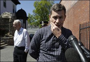 Ruslan Tsarni, right, uncle of killed Boston Marathon bombing suspect Tamerlan Tsarnaev, prepares to speak with reporters.