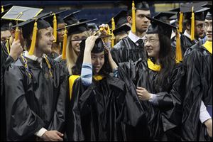 Graduates shift their tassles during commencement ceremonies for the University of Toledo's College of Business and Innovation, College of Natural Sciences and Mathematics, College of Visual and Performing Arts, and College of Languages, Literature, and Social Sciences.
