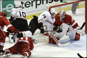 Anaheim Ducks left wing Matt Beleskey (39) trips over Detroit Red Wings right wing Daniel Cleary (11) as Detroit Red Wings goalie Jimmy Howard (35) defends in overtime of Game 4 of a first-round NHL hockey Stanley Cup playoff series in Detroit.