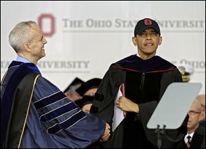 David Horn congratulates President Obama after he accepts an honorary doctor of laws degree at Ohio State's graduation ceremony at Ohio Stadium. Mr. Obama is the third sitting president to give Ohio State’s commencement address, following George W. Bush in 2002 and Gerald Ford in 1974.