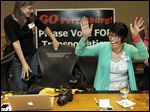  Two Perrysburg 4 Transit committee members celebrate the passage of the city's transportation levy this week.