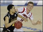  Wichita State's Fred Van Vleet (23) moves the ball as Louisville's Tim Henderson (15) defends during a the NCAA Final Four tournament semifinal game, April 6 in Atlanta. Louisville went on to defeat Michigan in the championship game.