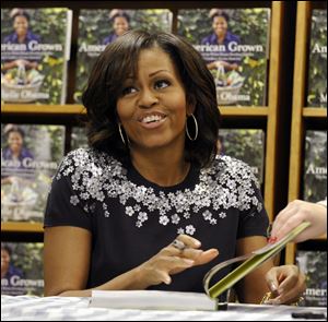 First lady Michelle Obama signs copies of her book 