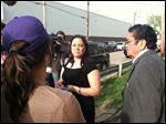  First cousin of the three suspects Maria Castro-Montes, center, speaks to the media on Cleveland's Seymour Avenue early today.
