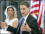  Ohio Treasurer Josh Mandel speaks to area business leaders, including Laura Glover of the Sylvania Area Chamber of Commerce, left, at the Wingate by Wyndham hotel in Sylvania.