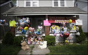 The front porch of Amanda Berry's home is decorated with balloons and signs in Cleveland.