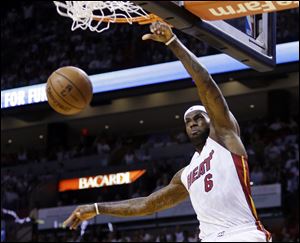 Miami Heat forward LeBron James dunks against the Chicago Bulls during the first half today in Miami.