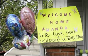 A sign on the porch greets Amanda Berry after her release from captivity. Ms. Berry was taken into her sister's home through a back door, out of sight from reporters and onlookers.