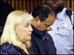  Ariel Castro and public defender Kathleen DeMetz, left, wait for his arraignment at Cleveland Municipal Court. Castro was charged with four counts of kidnapping and three counts of rape.  Ariel Castro was charged while his brothers, Pedro and Onil Castro, were held but faced no immediate charges.