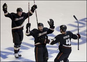 Anaheim Ducks center Nick Bonino, middle, celebrates his game winning goal with Cam Fowler, right, and Matt Beleskey against the Detroit Red Wings during overtime in Game 5.