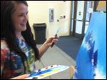  Senior Courtney Onofrey talks about her painting during her demonstration in front of family and friends at Perrysburg High School.